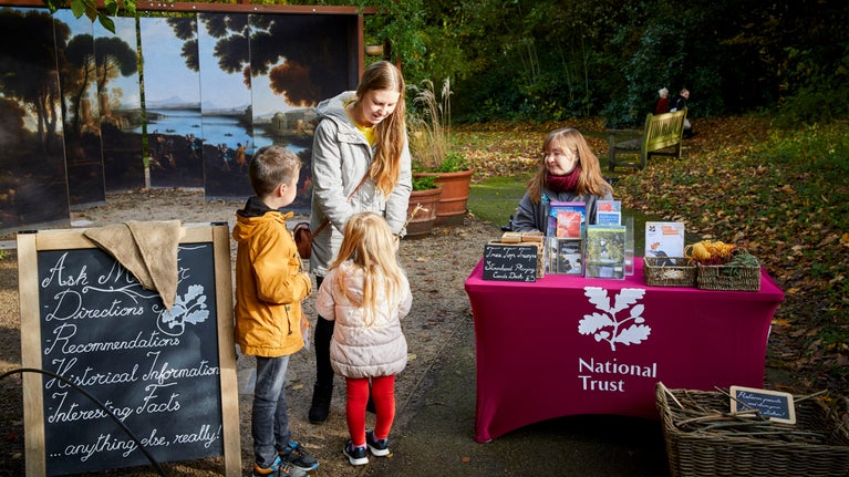 Visitors are greeted by a volunteer in the garden at Stourhead, Wiltshire